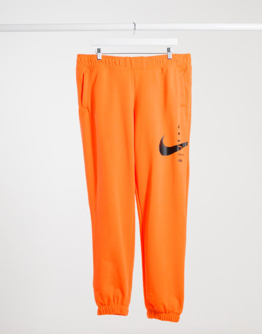 Nike Pantalon en polaire logo virgule Orange et noir ASOS