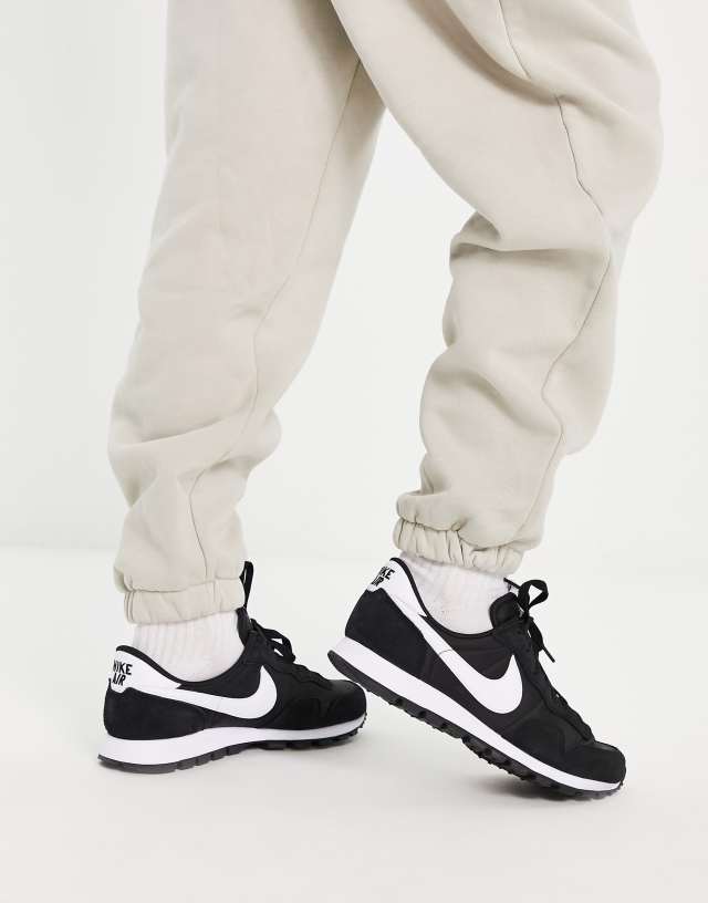 Nike Pegasus 83 sneakers in black and white