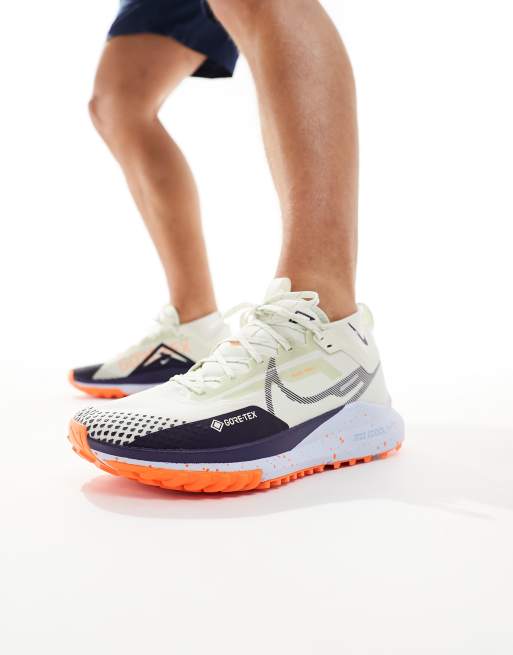 Nike Pegasus Trail 4 sneakers in cream and orange