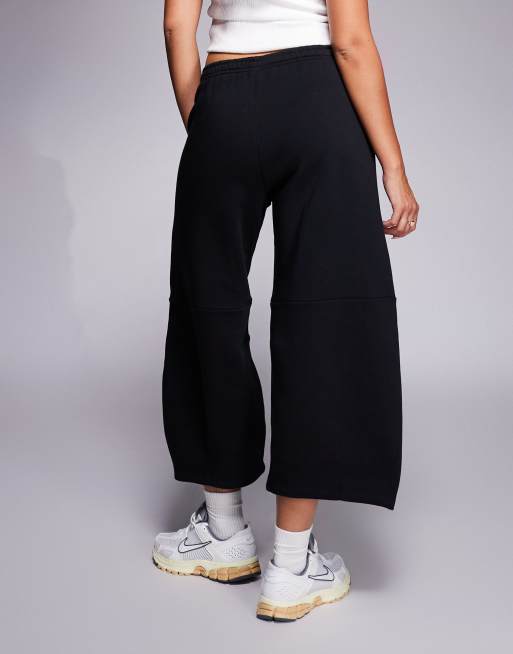 Nike Phoenix barrel leg pants in black | ASOS