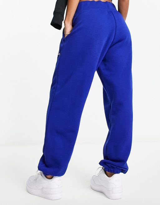 Nike Phoenix Pantalon de jogging unisexe en polaire avec inscription style universitaire Bleu roi