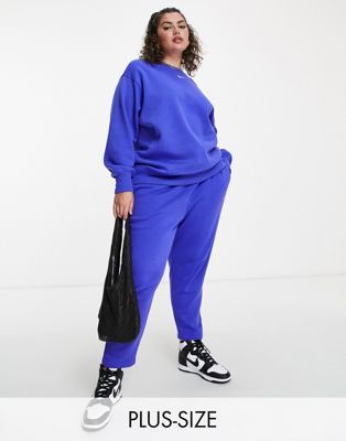 Nike Plus mini swoosh curved high rise joggers in lapis blue - ASOS Price Checker