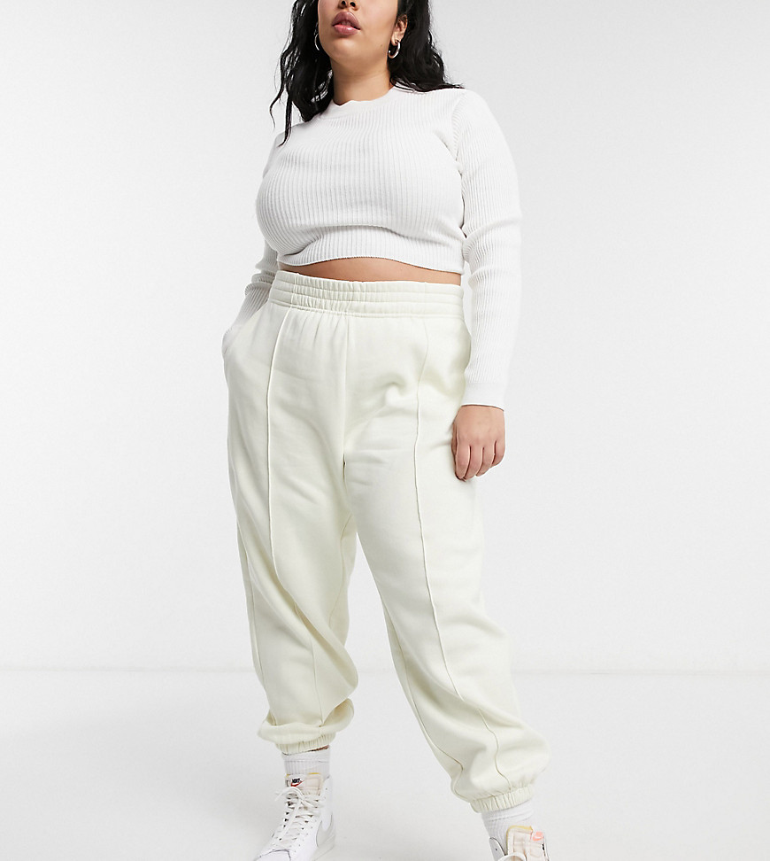 Nike Plus mini swoosh oversized sweatpants in off white