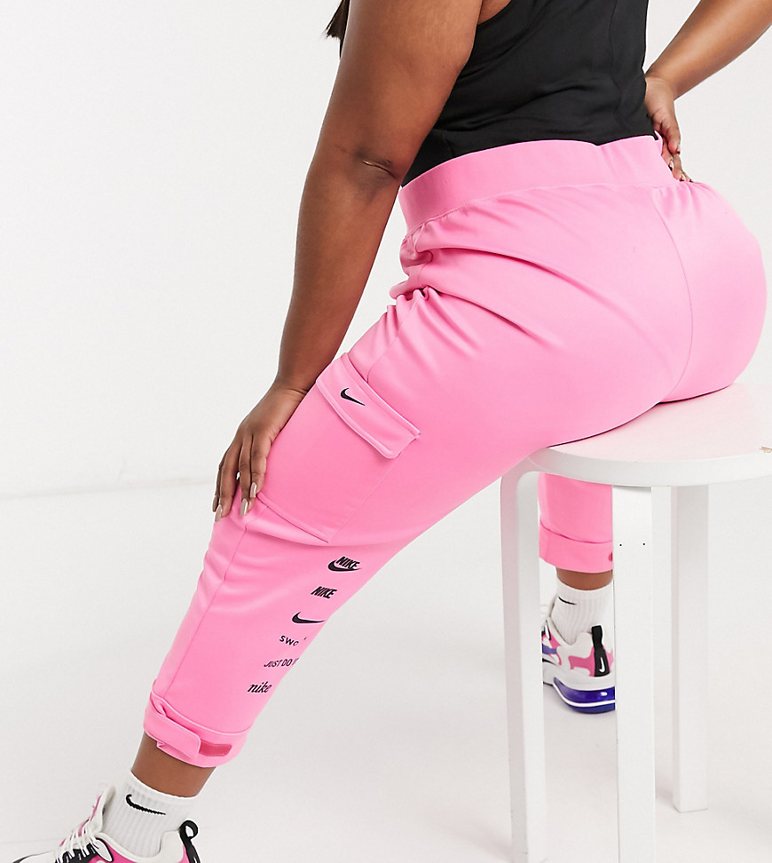 Nike Plus swoosh cargo pocket joggers in pink