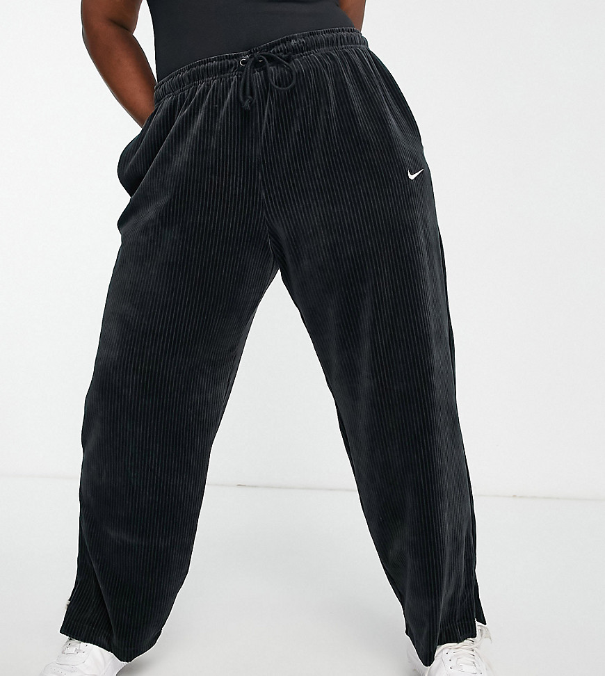 Joggers by Nike Add-to-bag material Drawstring waistband Side pockets Nike logo embroidery Wide leg