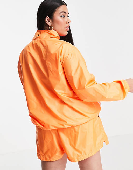Nike Plus washed woven jacket in orange and pink ombre
