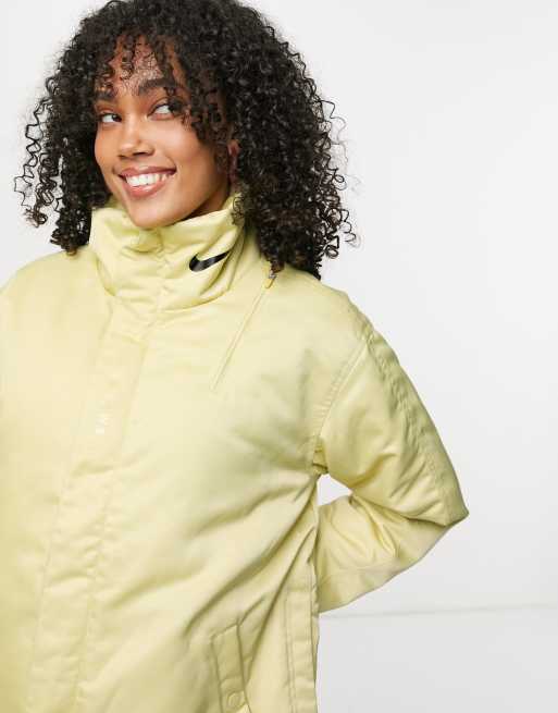 Nike premium jacket in gold with logo print collar ASOS