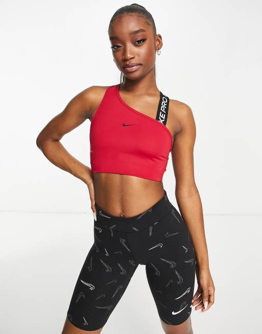 Nike Pro Training - Brassière de sport asymétrique maintien moyen en tissu  Dri-FIT avec logo virgule - Rose