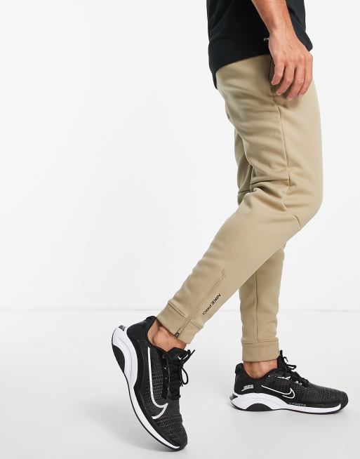 https://images.asos-media.com/products/nike-pro-training-therma-fit-sphere-joggers-in-stone/24343560-4?$n_640w$&wid=513&fit=constrain