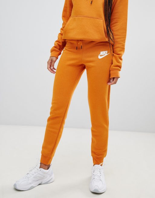 Nike - Rally Burnt - Pantalon de jogging à logo - Orange, ASOS