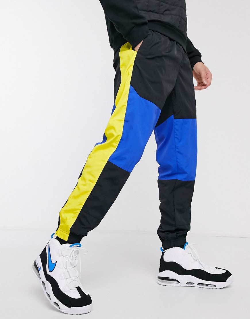 Nike Re-Issue woven cuffed joggers in black/blue
