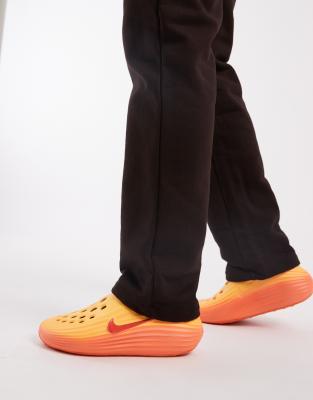 Nike ReactX sliders in orange