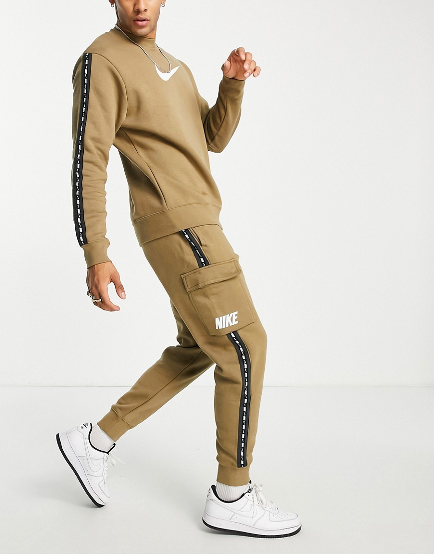 Nike Repeat logo taping cargo joggers in taupe-Brown