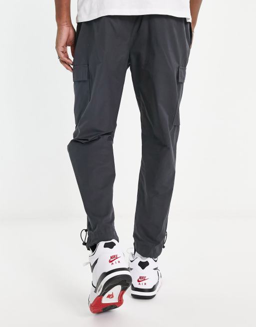 Nike repeat logo woven trousers in dark grey ASOS