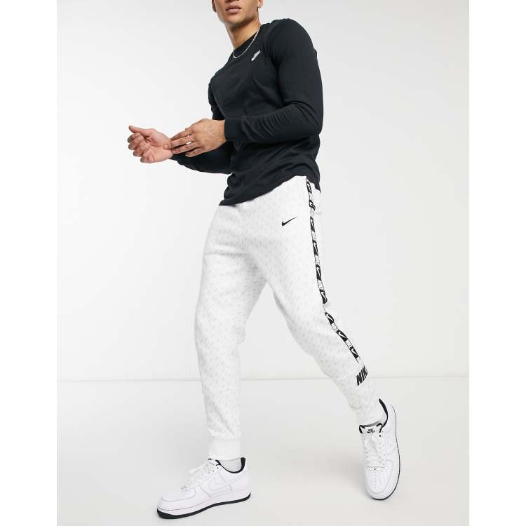 Nike Repeat Pack all over logo print taping cuffed joggers in white ASOS