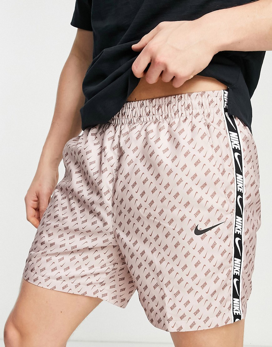 Nike Repeat Pack all over logo print woven taping shorts in dusty pink