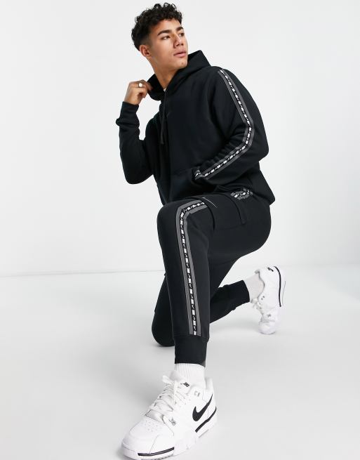 Nike taped track pants hot sale black