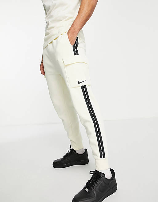 Nike Repeat Pack logo taped cargo joggers in off white | ASOS