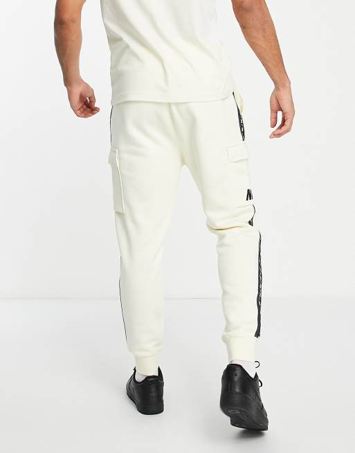 Nike repeat pack polyknit logo taping cuffed joggers in white hot sale