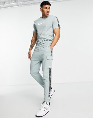 Nike Repeat Pack logo taped cargo trackies in sage - ASOS Price Checker