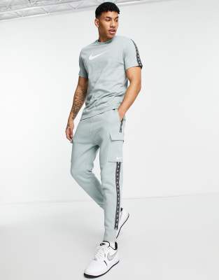 Nike Repeat Pack logo taped cargo trackies in sage - ASOS Price Checker