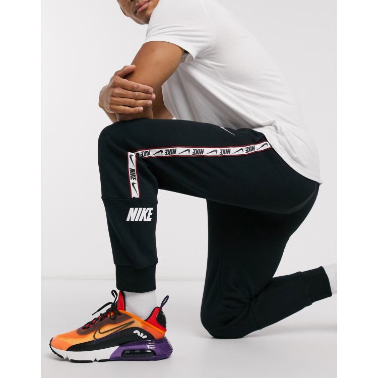 Nike Repeat Pack logo taping cuffed joggers in black ASOS