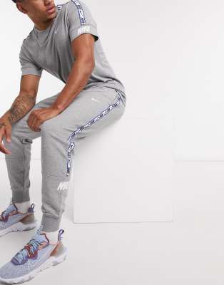 nike logo taping cuffed joggers in grey