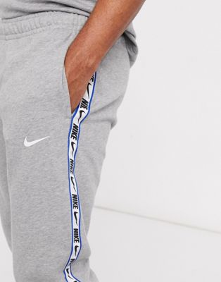 nike logo taping cuffed joggers in grey