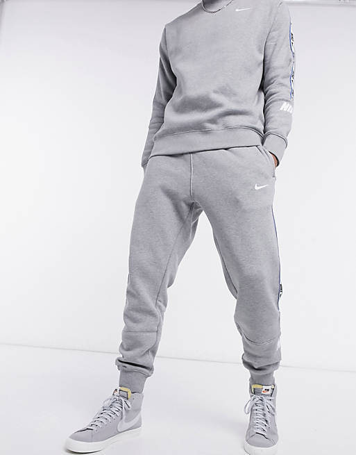 Nike Repeat Pack logo taping cuffed joggers in grey