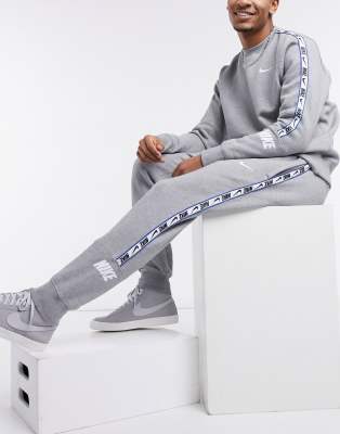 nike logo taping cuffed joggers in grey