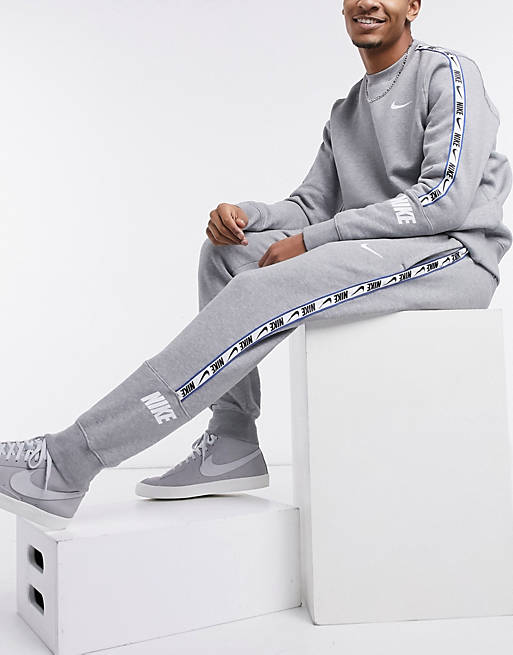 Nike Repeat Pack logo taping cuffed joggers in grey