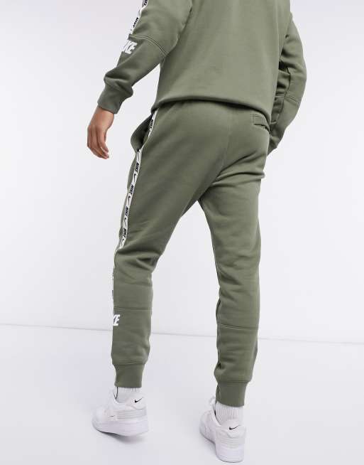 Nike repeat pack logo taping cuffed joggers best sale in grey