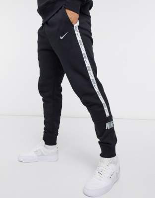 nike repeat tape track pants