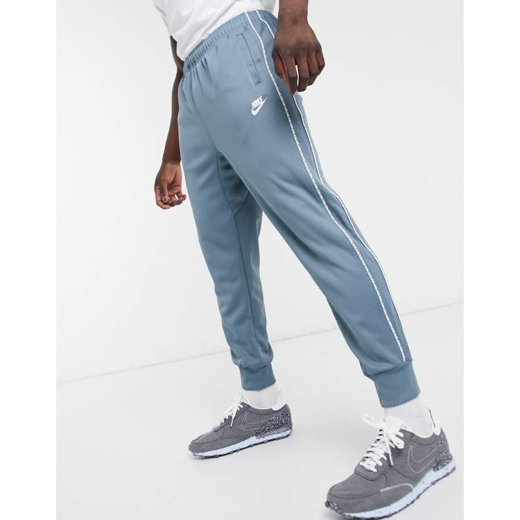 Nike Repeat Pack logo taping polyknit cuffed joggers in steel blue