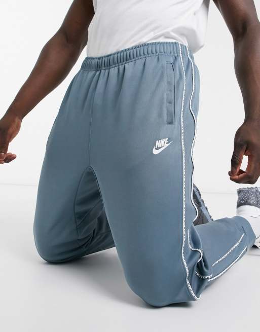 Nike repeat pack polyknit logo online taping cuffed joggers in white