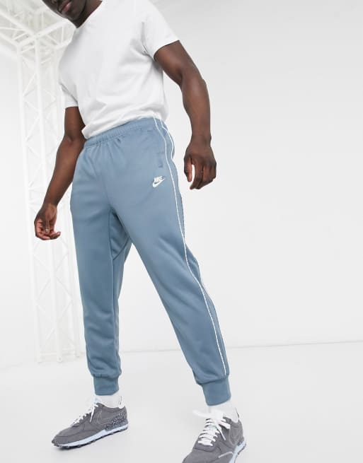 Nike Repeat Pack logo taping polyknit cuffed joggers in steel blue