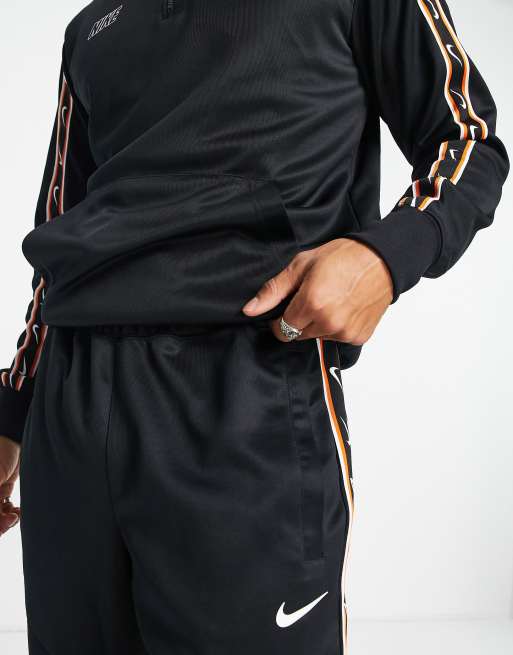 Nike repeat tracksuit store black and gold