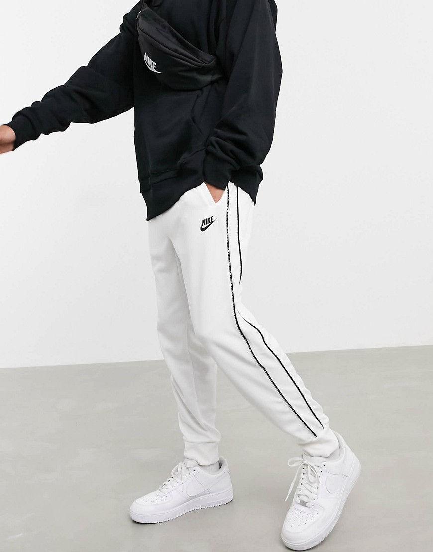 Nike Repeat Pack polyknit logo taping cuffed joggers in white