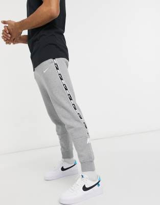 nike repeat pack logo taping cuffed joggers in khaki