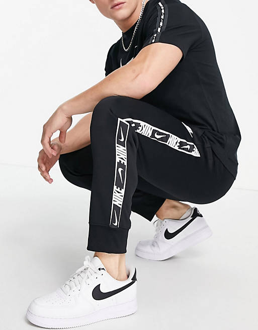 Nike Repeat taping polyknit jogger in black