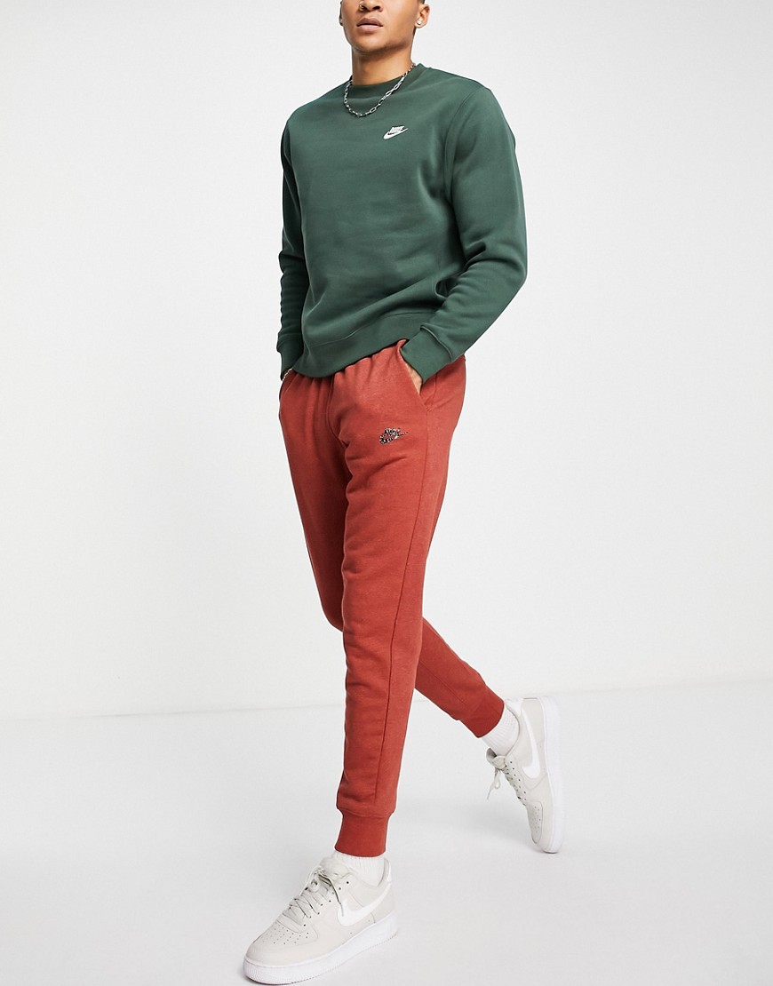 Nike Revival cuffed fleece sweatpants in dusty red