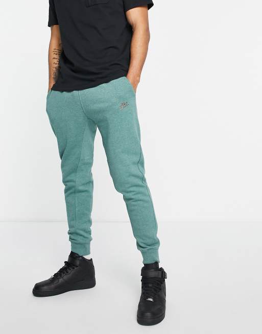 Nike Revival cuffed joggers in teal heather MBLUE ASOS