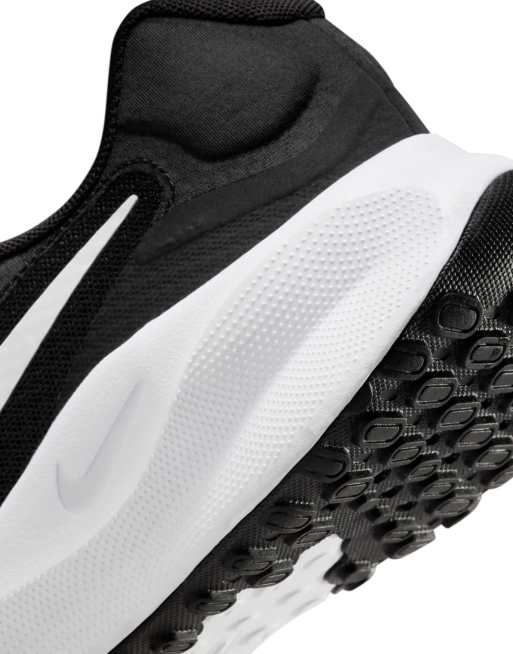 Nike Revolution 7 sneakers in black and white