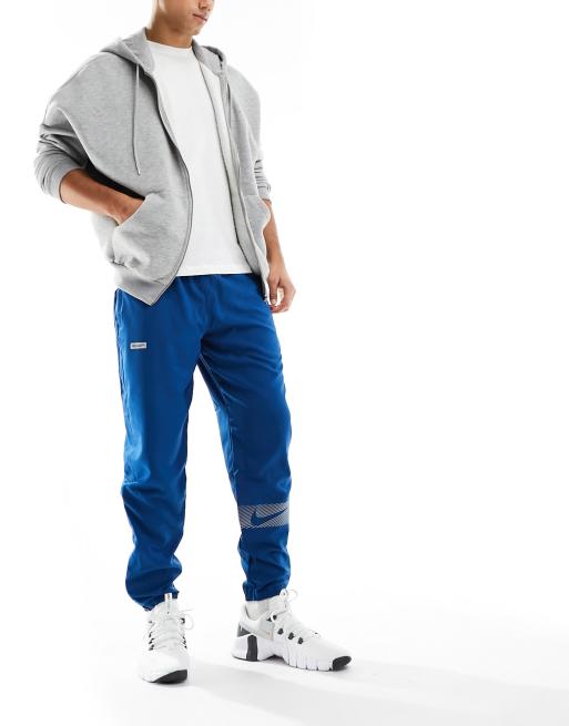 Nike Running Dri-Fit Flash Challenger reflective woven joggers in blue