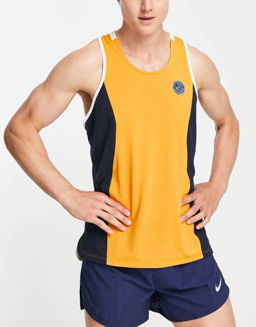 Nike Running Heritage Dri FIT tank in gold