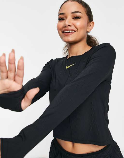 Nike Running Icon Clash gold logo long sleeve top in black