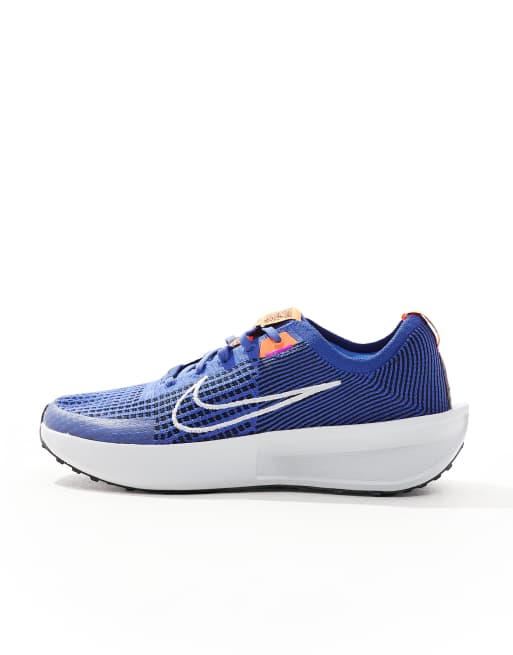 Nike Running Interact Run sneakers in blue and white ASOS