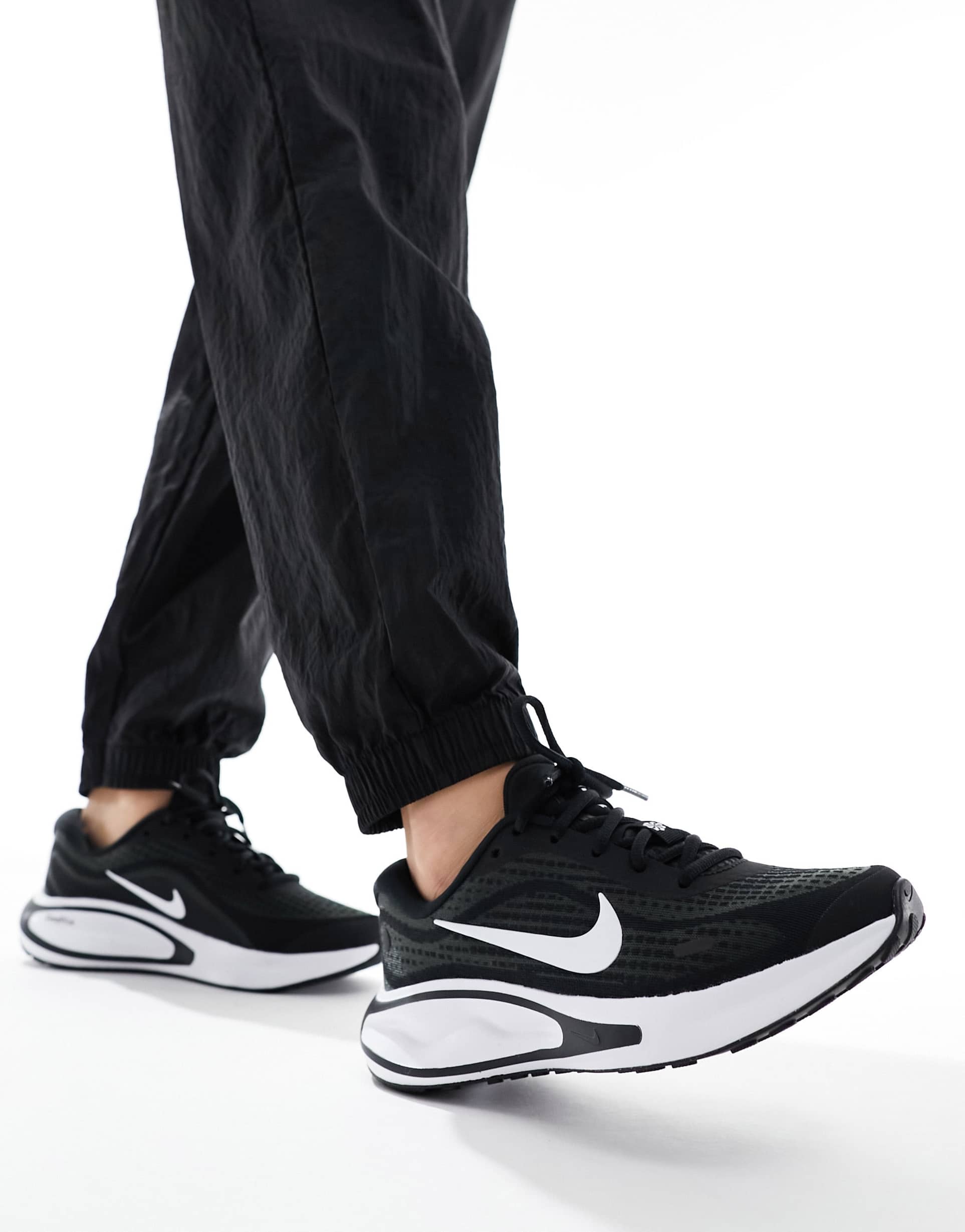 nike running journey run sneakers in black and white