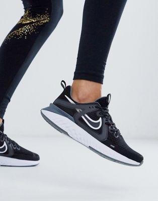 nike running legend react trainers in black and white