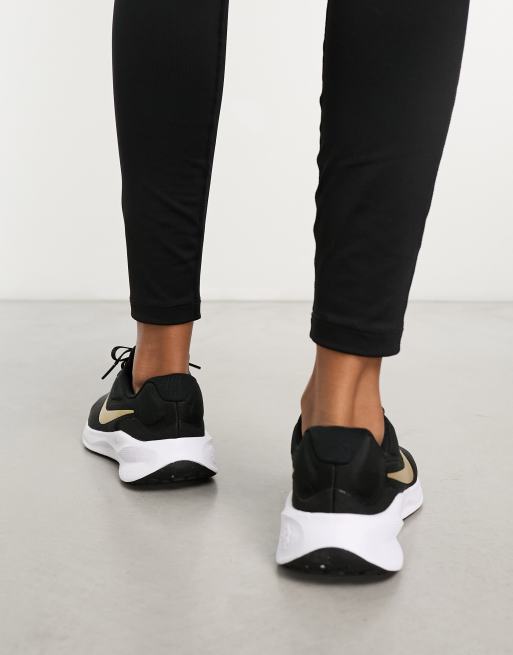 Nike Running Revolution 7 Sneaker in Schwarz und Gold ASOS